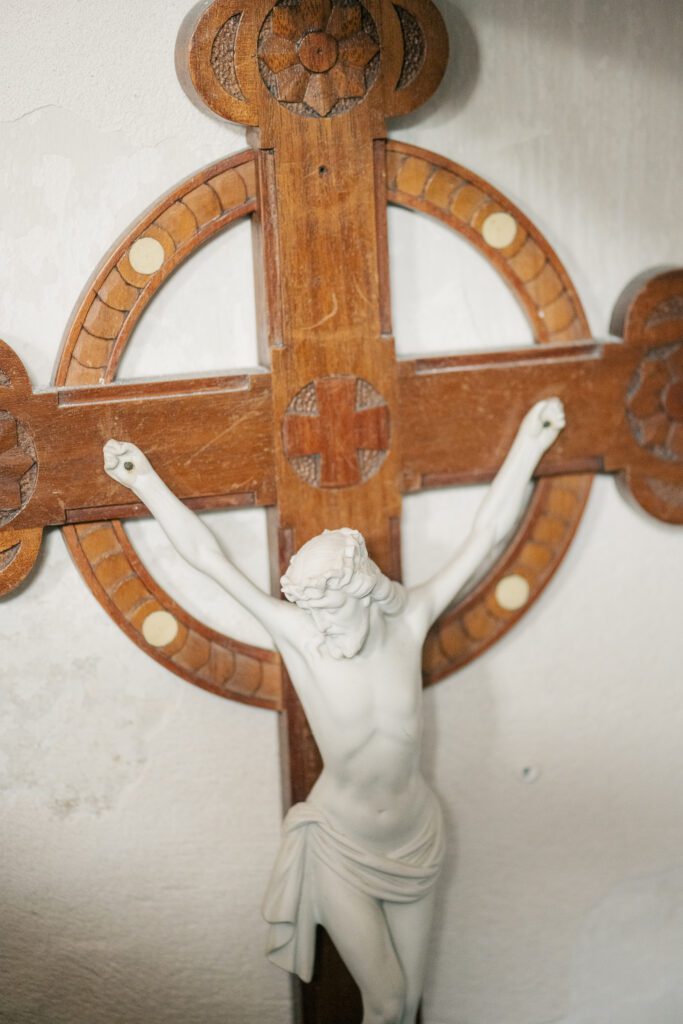 white porcelain and wood crucifix that hung on the wall of our house when we bought it