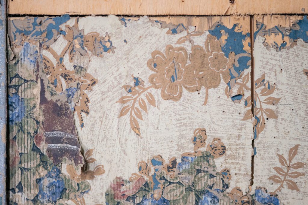 detail of old wallpaper layers on old wood bedstee wall found in municipal monument in Nuenen