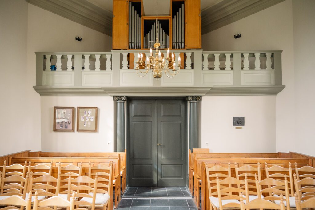 Interior view of entrance doors and chairs in the Van Goghkerkje, little historic Protestant chapel in Nuenen where Vincent Van Gogh's father was the preacher