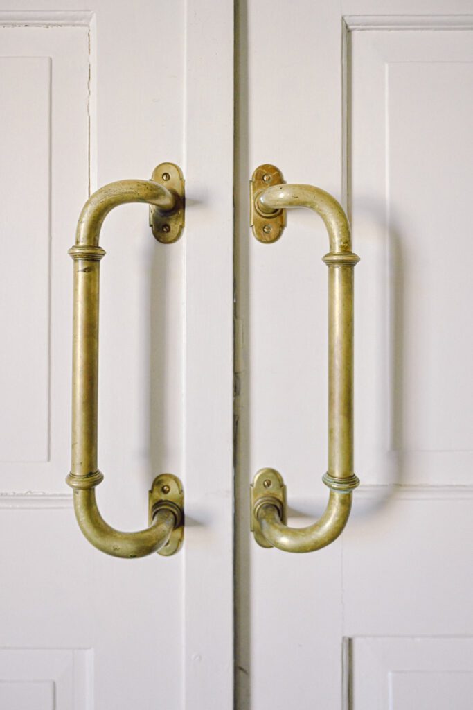Detail of two brass handles on a double door at D'n Kleine Dommel