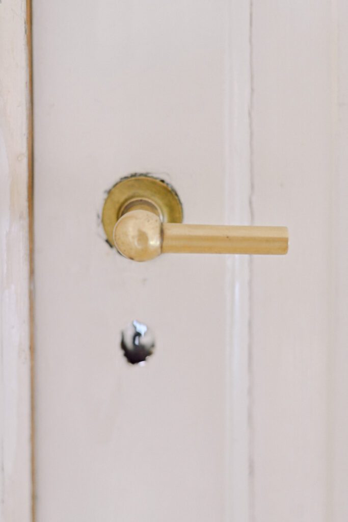 detail of a brass handle and vintage keyhole of one of the doors